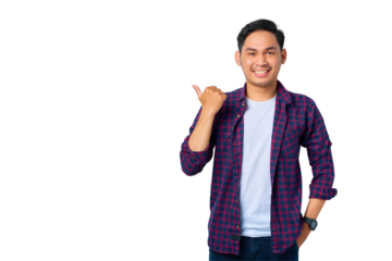 Cheerful young Asian man in plaid shirt pointing thumbs at copy space, advertisement banner isolated on transparent background