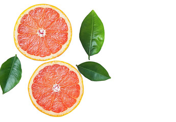 Freshly cut grapefruit displayed with green leaves on a light background showcasing its vibrant color and texture