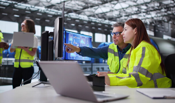 Engineer Operating Control Panel At Power Plant Generating Electricity