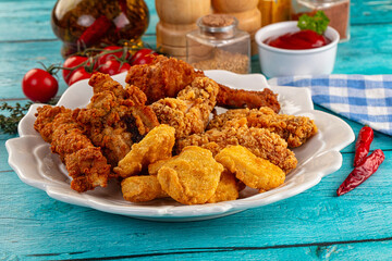 Golden crispy fried chicken mix - wings, drumsticks, nuggets and strips