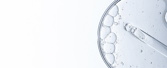 Cosmetic moisturizing gel or skin serum in a petri dish. Copy space