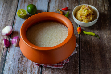 Panta bhat is fermented soaked rice, typically served with mashed potatoes (alu seddho), offering a tangy, comforting, and nutritious dish popular in Bengali cuisine.
