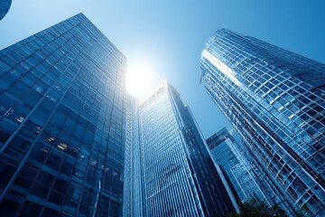 Obraz premium Modern Glass Skyscrapers in a City Center Under Bright Sunlight