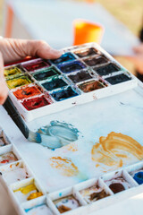 Artist Mixing Colors on Paint Palette with Brush