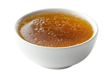 Rich golden broth in a white bowl a comforting culinary delight