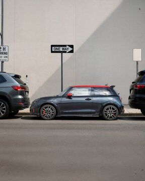 The car is parallel parked between two cars