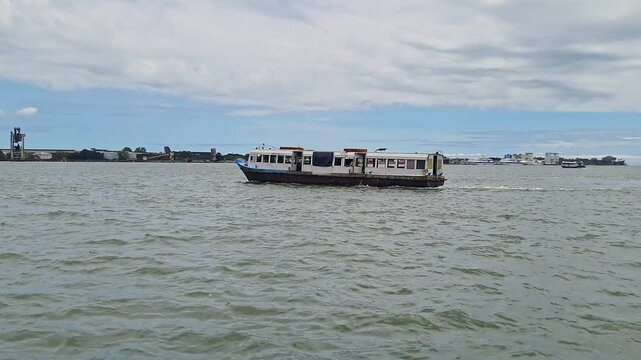 A video of water bus or water taxi departing from Kochi Water Metro station during the day