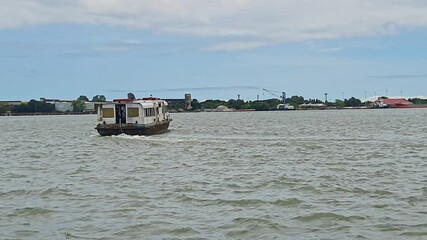 A video of water bus or water taxi departing from Kochi Water Metro station during the day