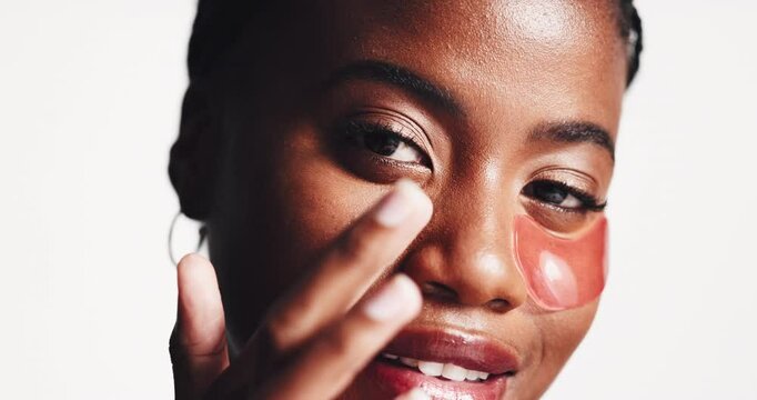 Face, dermatology and black woman with eye patches in studio isolated on white background. Skincare, beauty and cosmetics for female model with facial collagen mask for healthy skin and anti aging
