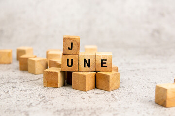 Wooden blocks with June text isolated on gray background