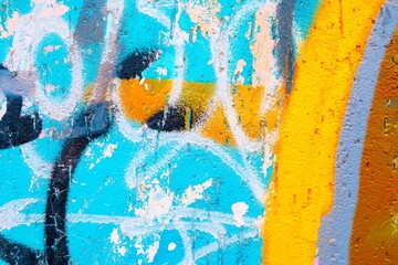 Vibrant graffiti wall features turquoise, orange, gray with abstract patterns. Urban artistic style, modern 2000s expression, bold, colorful. Posters, digital art, street visuals.