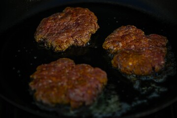 High resolution close up color image of the preparation of smash cheeseburgers on the grill- Israel