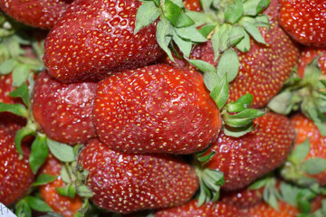 Top view of fresh and juicy red strawberries arranged in basket. A close-up of fruits in a grocery store. Fresh harvest. Healthy eating. Organic produce. Fruit market, strawberry background closeup