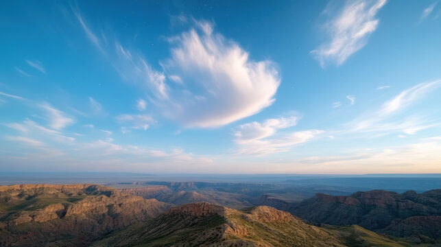 Breathtaking canyon landscape with rolling hills and vast sky filled with clouds