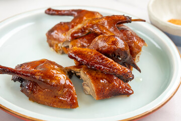 Crispy roasted pigeon on a plate