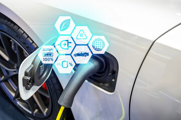 Power cable pump plug in charging power to electric vehicle EV car.