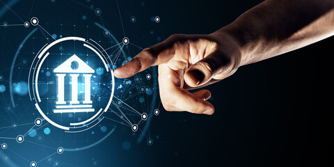 Hand touching digital banking icon with glowing technology interface on dark background representing modern financial services concept.