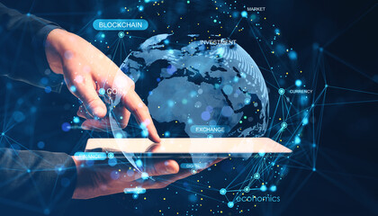 Businessman's hands interacting with digital tablet showing global network connections, blockchain, finance, and digital economy overlayed on Earth.