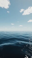 Obraz premium Calm ocean expanse under a light, cloudy sky. A serene view of the open sea