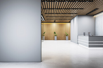 Modern office reception area with blank grey wall for signage or branding, wood panel ceiling and plants in sleek planters. 3D Rendering. 3D Rendering
