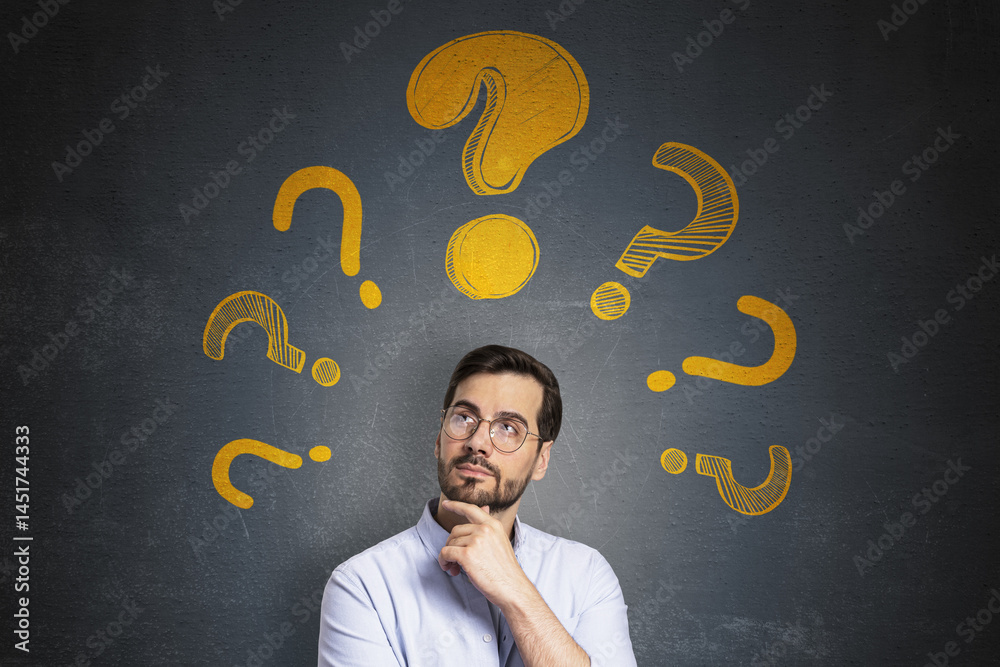 Poster Thoughtful man with glasses thinking under multiple yellow question marks on dark textured background, symbolizing creativity and ideas concept.