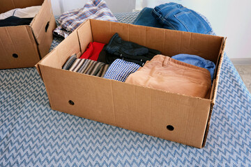 Several cardboard boxes for donations with things. Help for the poor and needy people.