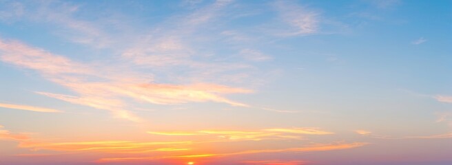 Fototapeta premium Sky with clouds at sunset showing orange pink and blue colors. luxury premium real sunset and sunrise photo collection for background
