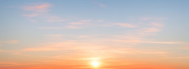 Sky with clouds at sunset featuring orange and blue colors. luxury premium real sunset and sunrise photo collection for background
