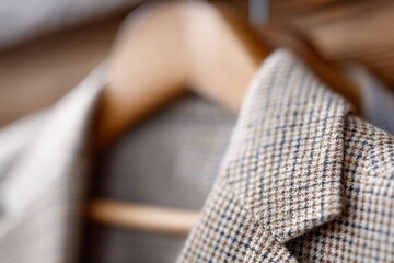 Fototapeta premium A close up of a suit hanging on a wooden hanger