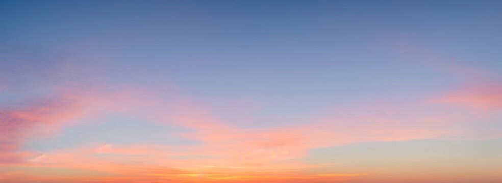 Sky with clouds at sunset or sunrise; colors of orange pink and blue. luxury premium real sunset and sunrise photo collection for background