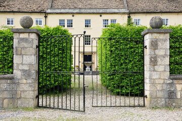 Gated entrance to a beautiful old mansion house on a street in an English town