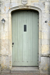 Wooden front door of a beautiful cottage house on a street in an English town