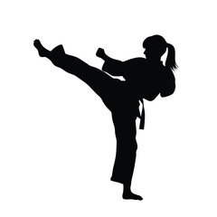 Silhouette of a Martial arts lady karate athlete performing a high kick