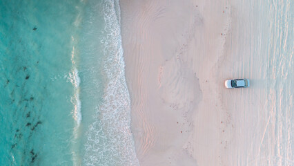 Aerial view of the beach with a car parked