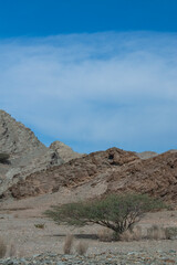 Oman, Middle East, 03-08-2025: driving on the roads of the Sultanate of Oman, panoramic view of mountains and desert landscape on the road between Muscat and Nizwa crossing remote villages