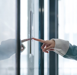 Hand pressing elevator button © Xiuxia Huang