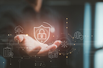 A hand displays a glowing padlock shield, symbolizing digital security and protection against cyber threats.
