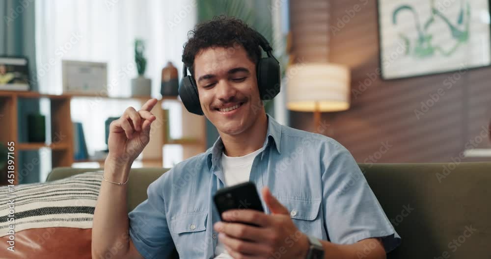 Poster headphones, dance and man with cellphone on sofa in home for chatting, relaxing and listening to mus