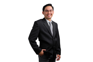 Confident young Asian businessman in black suit smiling and posing with hand in his pocket, isolated on transparent background