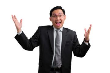 Excited young Asian businessman in black suit celebrating success with hands raised isolated on transparent background