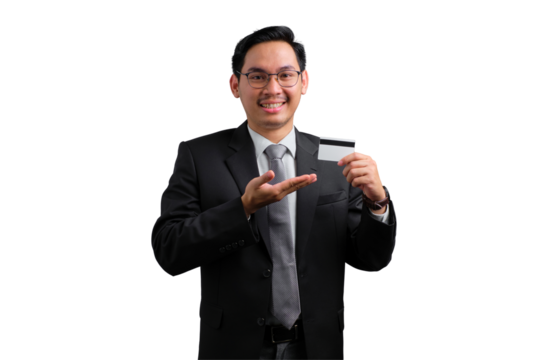 Confident young Asian businessman holding credit card and smiling isolated on transparent background