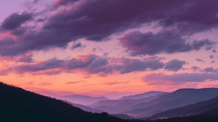 Obraz premium Breathtaking Sunset Sky Turning Purple and Orange Over Mountains