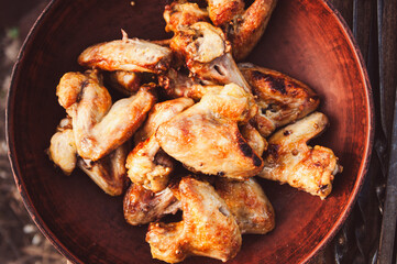 Crispy grilled chicken wings plate. Top view close-up