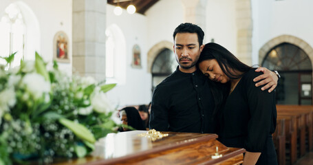 Couple, coffin and embrace at funeral for death, pay respect or comfort for loss in christian...