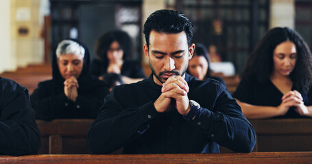 Religion, prayer and man in church with congregation for memorial, burial or funeral service. Worship, spiritual guidance and male person with praying for hope, faith or respect with gospel in chapel