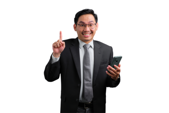 Happy young Asian businessman pointing up while holding smartphone isolated on transparent background