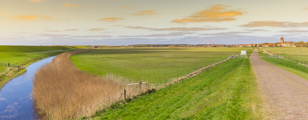 Naklejka premium Panorama of sunset over the landscape and Hollum village in Ameland, Netherlands