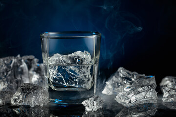 Crystal clear vodka or gin in a glass with ice.