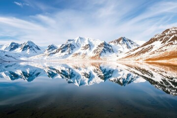 Obraz premium Serene Snow-Capped Mountains Mirrored in Still Water: A Peaceful Landscape