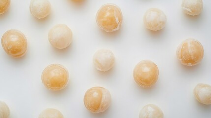 Obraz premium Top down view of peeled whole longan fruits on white background translucent tropical fruit frequently imported to USA for sweet juicy treats and fruit bowls cut out on isolated transparent background